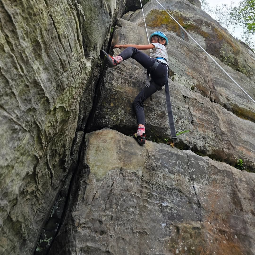 Children learning outdoor rock climbing on Southern Sandstone in Tunbridge Wells.