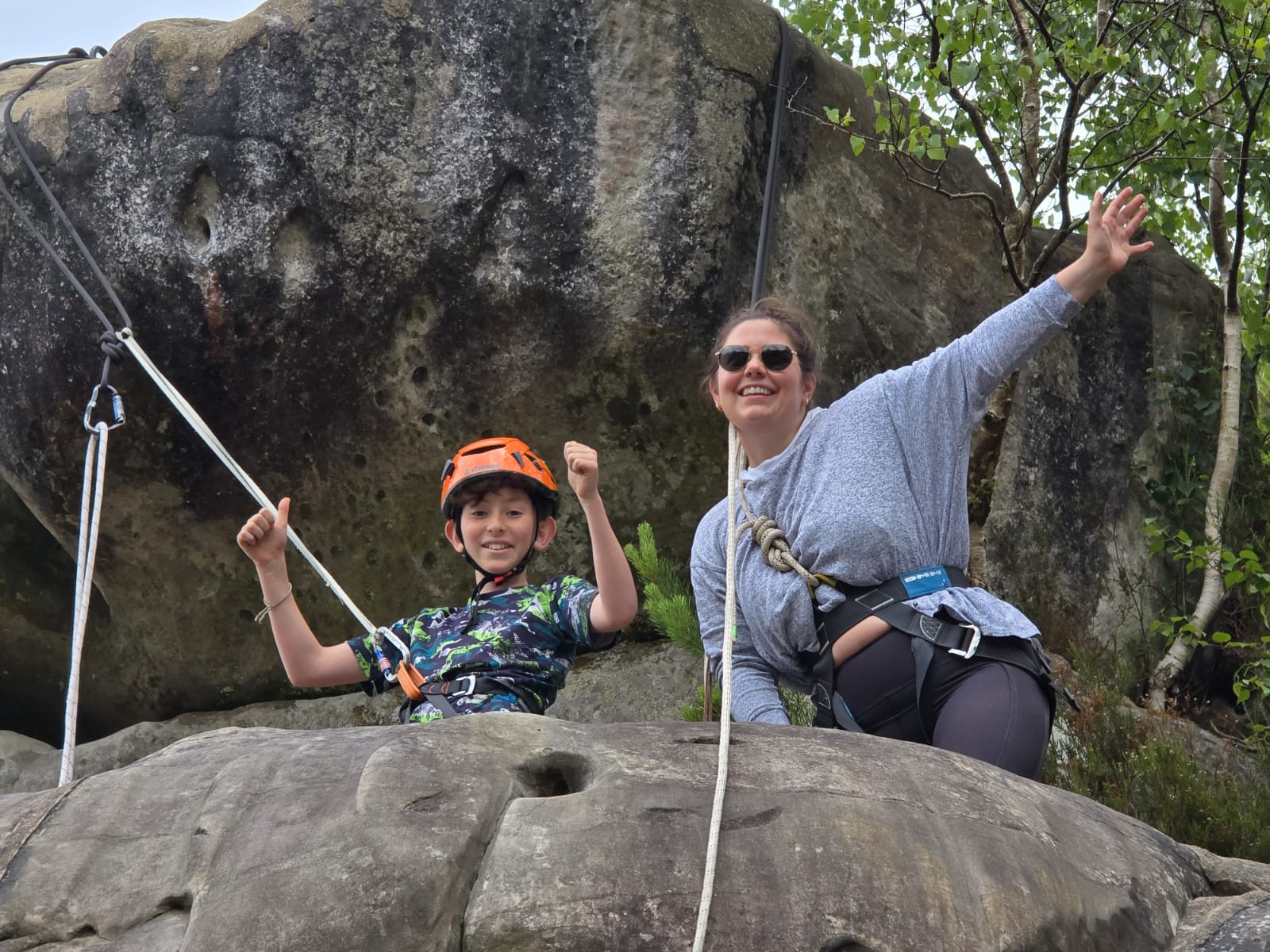Family enjoying an outdoor rock climbing adventure on Southern Sandstone with an instructor.